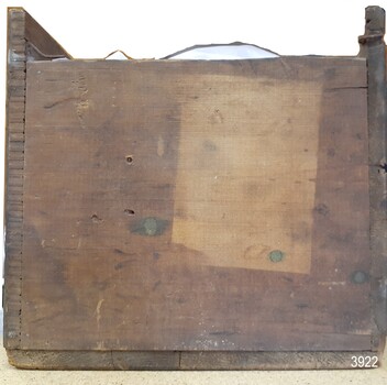 View of end of box, plans visible, area where once a label was attached 