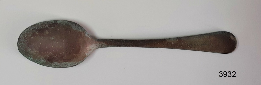 Teaspoon has text stamped on handle