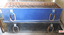 Black box with wooden handles below identically fitted out box