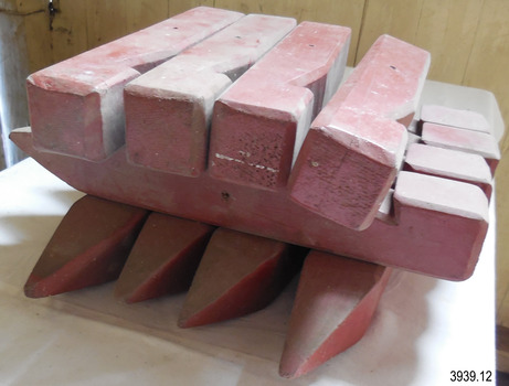 Pegs have square shank profile, bevelled edges, hole near centre of length. 