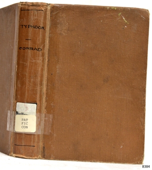 Brown hardcover book with inscription on its spine