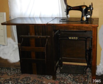 Cabinet is fitted with shelves, machine is operated by treadle