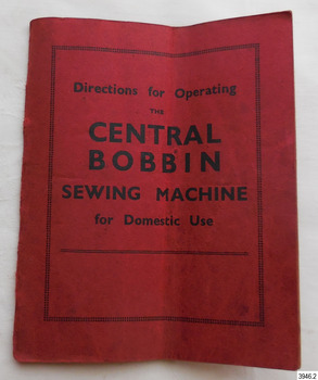 Red covered book containing instructions for the machine