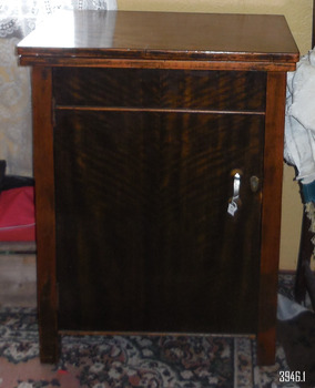 Cabinet folds up with worktop on top of the sewing machine table. Timer has decorative grain.