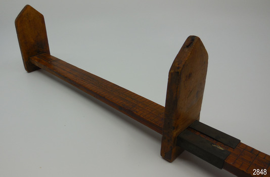 View shows sliding arm close to camera, showing gap in metal sleeve.