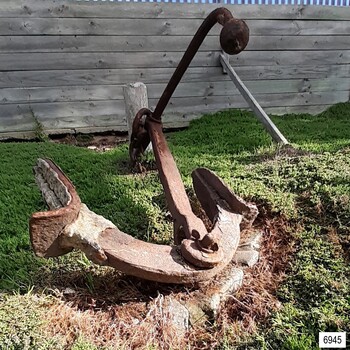 Anchor has two flukes with upright palms, rectangular section shank and round section stock