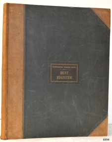 Hard covered book, dark cloth front cover, light brown reinforced spine and corners. 