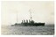 Black and white photograph, battleship with ships in background