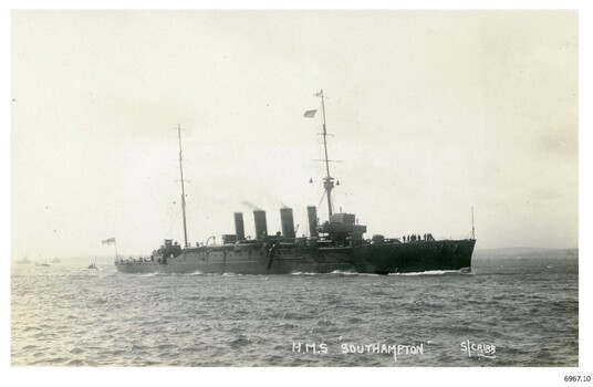 Black and white photograph, battleship with ships in background