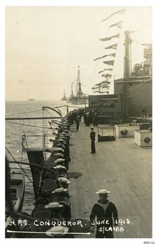 Black and white photograph, looking across the deck towards other ships