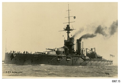 Battleship in black and white photograph, funnels smoking