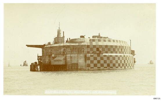 Sepia photograph of a sea fort,sailing ships in the background