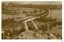 Ships in port, figures watching on in crowd. Sepia photograph