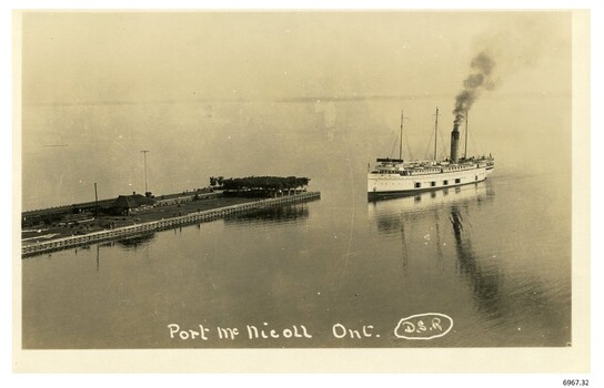 Ship approaching a pier with a tree plantation on its end and figures walking around