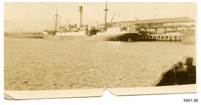 Sepia, small photograph of a ship in port, maybe the Nestor