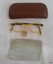 The brown case contained the spectacles, a cleaning cloth and a price tag.