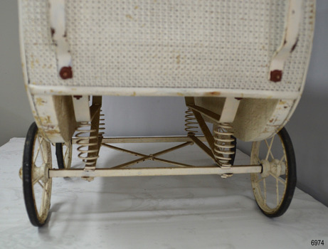 Underside of pram has springs on axles, front and back. Tyres are black