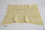 Cream coloured rectangular knitted blanket with embroidered motifs