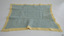 Blanket is lined with blue knitted rectangle
