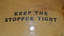 Inscription is two lines of text stenciled onto surface of bottle