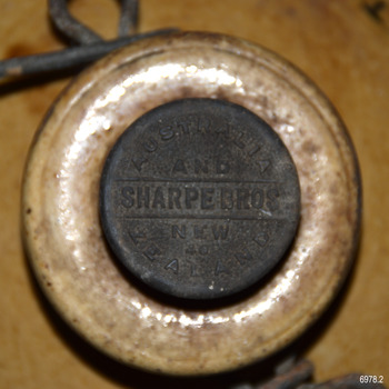 Black top of stopper has embossed maker's details 