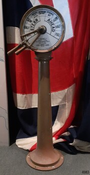Dial on top of a brass pedestal