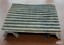 Corrugated iron stand has short legs to raise it above the surface