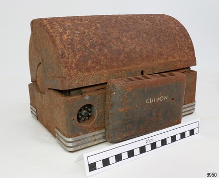 Electrical socket for microphone on left, cover with vents and maker's name in centre