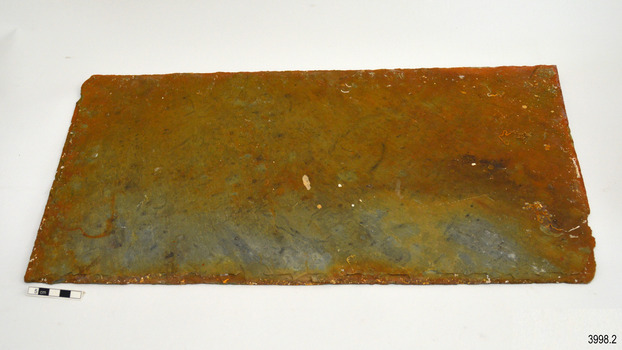 Tile flat on table, brown stains on blue-grey surface