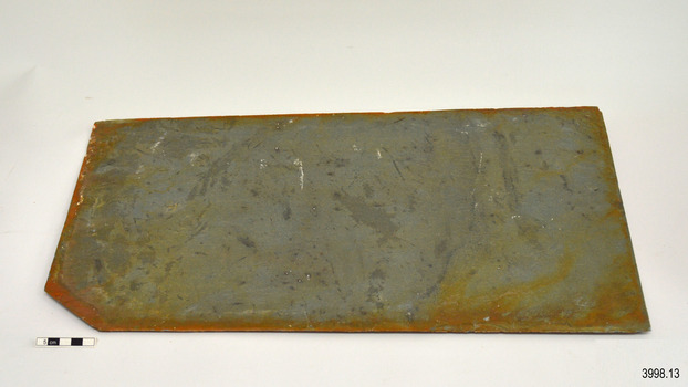 Tile has a broken corner and blue-grey colouring