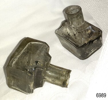 Bottles have uneven glass thickness, seams, burst lips, bubbles, imperfections