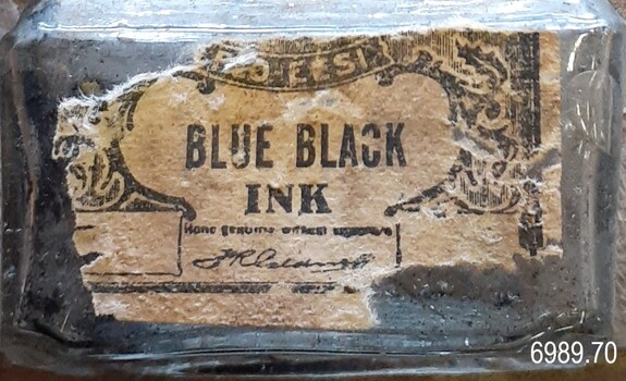 Front of bottle has a label with inscriptions