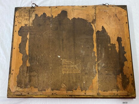 Back of the frame with handwritten inscriptions in black ink