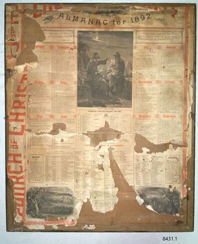 A large paper almanac stuck to the rear of the frame. Text is in red and black ink; it also has black and while biblical figures.
