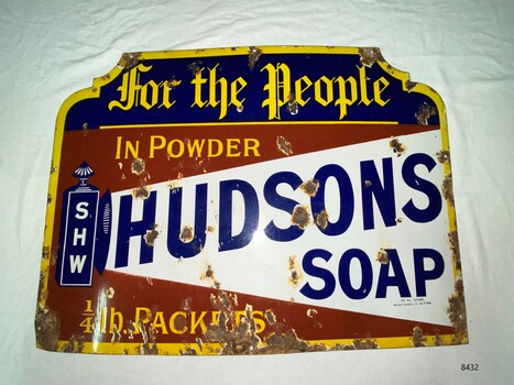 A large square advertising sign for Hudson's soap with white, blue red and yellow colours