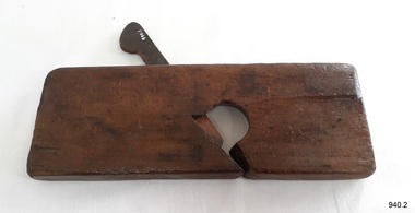 Dark stained wood plane with wedge inserted, no blade