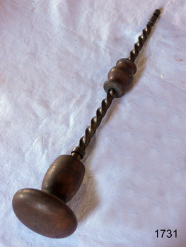 Drill has a round wooden handle and a wooden grip