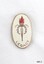 Gold metal and white enamel badge with symbol of flaming torch