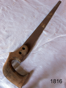 Saw with wooden handle has a long narrow blade. The end is straight.