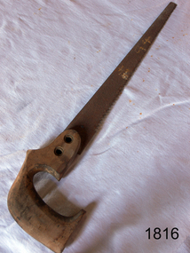 Saw with wooden handle has a long narrow blade. The end is straight.