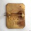 Reverse has a horizontal pin and stamped and embossed inscriptions