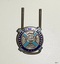 Round silver metal badge with light and dark blue enamel, inscriptions and symbol of a burning bush