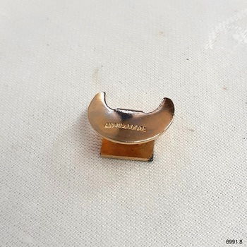 Badge's reverse is a crescent-shaped fastener