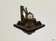 Metal and enamel badge, symbol 'crown' above 'rays radiating from the sun'