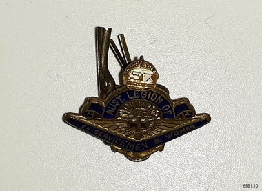 Metal and enamel badge, symbol 'crown' above 'rays radiating from the sun'