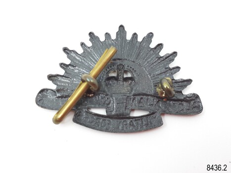 Badge has brass eyelets and pin
