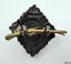Badge has two eyelets and a pin to join it onto the uniform