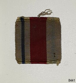 Ribbon has vertical stripes; a narrow blue stripe and wide red stripe
