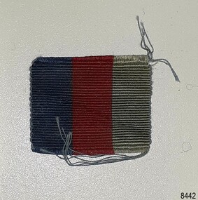 Cloth ribbon has vertical stripes of blue and red or crimson