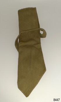 Khaki coloured narrow tie with uneven angle on the front edge